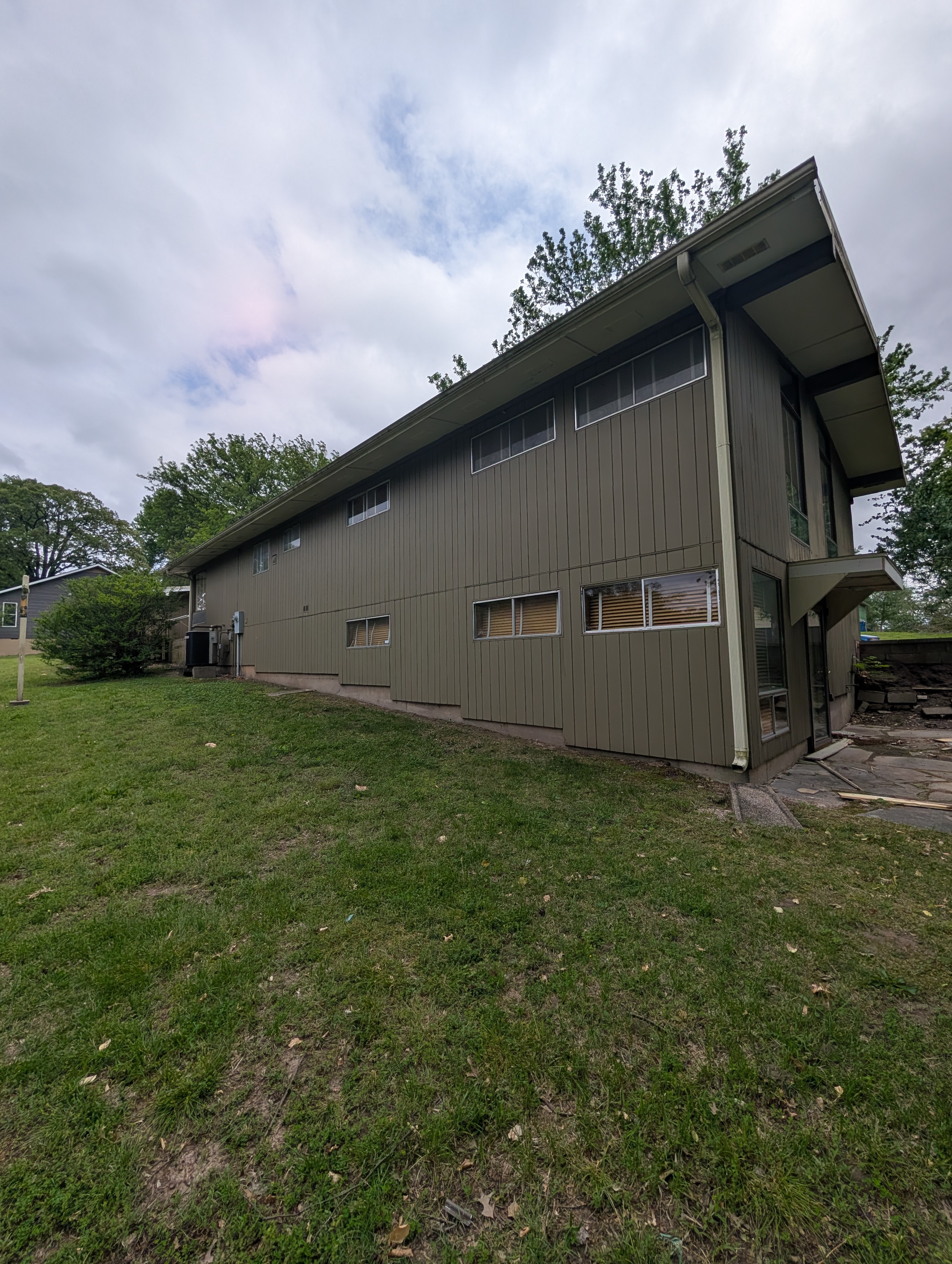 Before wood repair — deteriorating fence, fascia, soffit, and deck in Joplin, MO